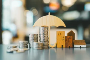 Money and buildings under umbrella